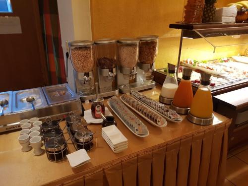 a counter with a bunch of food items on it at Hotel Drei Kronen in Dortmund