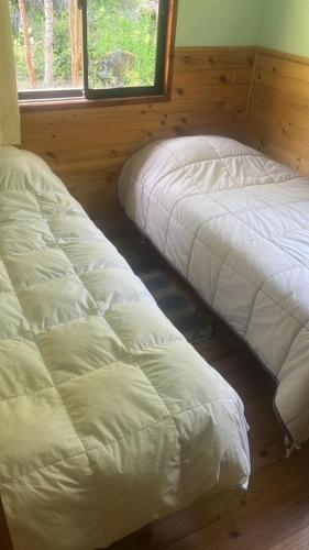Postel nebo postele na pokoji v ubytování Cabañas Namoncahue