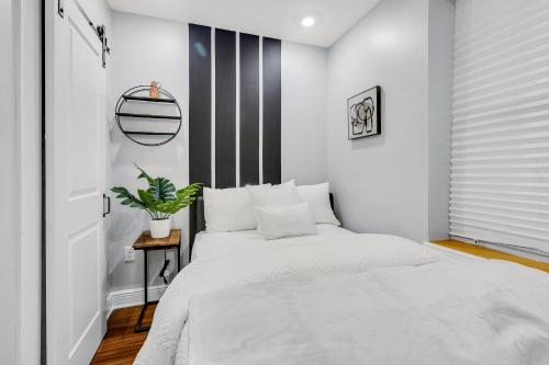 a bedroom with a white bed and a black and white wall at Fairmount Art Museum Center City in Philadelphia