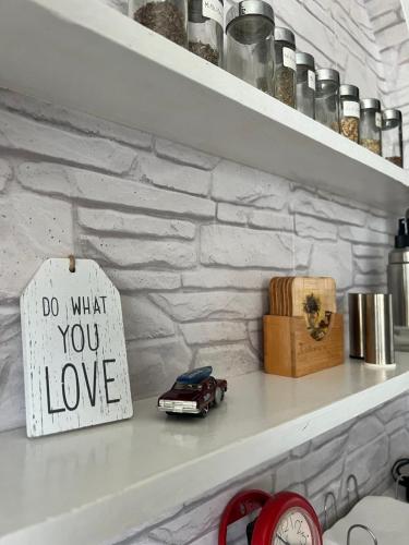 a shelf with a sign that says do what you love at Genex 37 in Novi Beograd