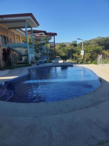 a swimming pool in front of a house at Villa Teresita - vista hermosa in Coco