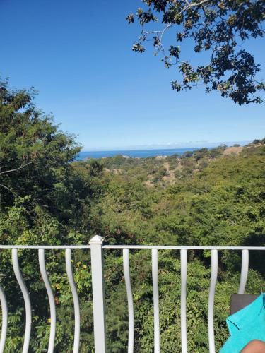 a white fence with the ocean in the background at Villa Teresita - vista hermosa in Coco