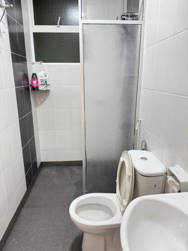 a small bathroom with a toilet and a sink at Sandakan IJM condo full-equipped homestay in Sandakan