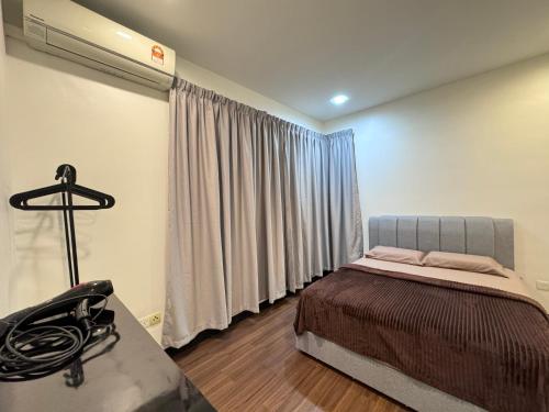a bedroom with a bed and a desk and a window at Sandakan IJM condo full-equipped homestay in Sandakan