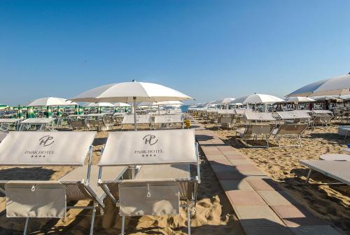 a row of chairs and umbrellas on a beach at Park Hotel Cattolica & Restaurant in Cattolica