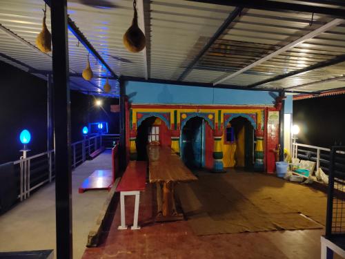 a play room with a table and a playground at Shoonya Home Stay - Devalsari Deodar Forest Range - 60min from Mussoorie in Mussoorie