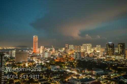 a city lit up at night with buildings at Seaview Mansion One Georgetown in George Town