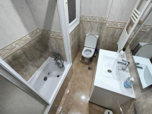 a bathroom with a tub and a sink and a toilet at Vintage House in Vigo