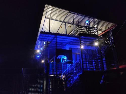 a building with blue lights on it at night at Shoonya Home Stay - Devalsari Deodar Forest Range - 60min from Mussoorie in Mussoorie