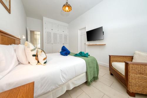 a bedroom with a white bed and a tv at Mar Azul Puerto Calero in Puerto Calero