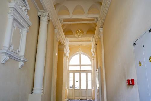 a hallway with columns and a large window at Centrally Located Gem in Prague in Prague