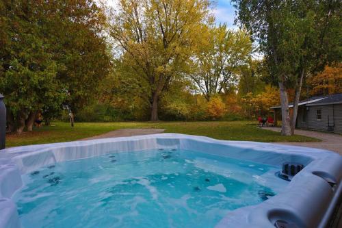 a hot tub in the backyard of a yard at Spacious Pickleball Pines in South Haven