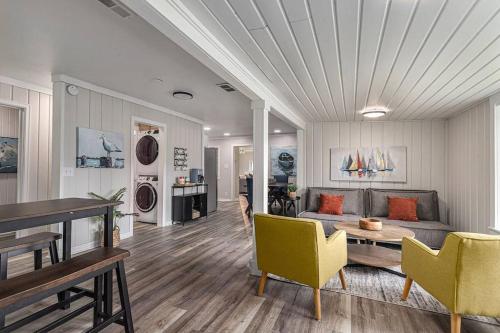 a living room with a couch and a table and chairs at Spacious Pickleball Pines in South Haven