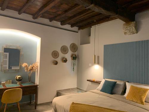 a bedroom with a bed and a desk and a television at La corte di Frascati in Frascati