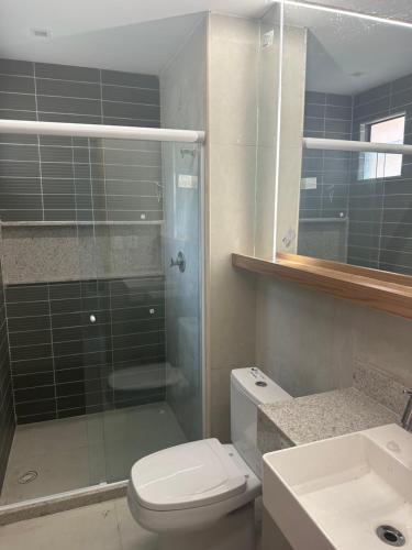 a bathroom with a shower and a toilet and a sink at Eco resort praia de carneiros in Praia dos Carneiros