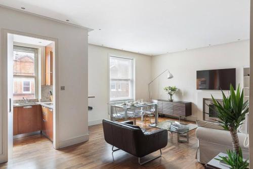 uma sala de estar com um sofá e uma mesa em The Sophisticated Apartment in Knightsbridge em Londres