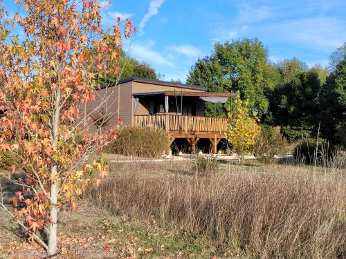 a house in the middle of a field at Les Chalets du Moulin de Valade in Condat-sur-Trincou