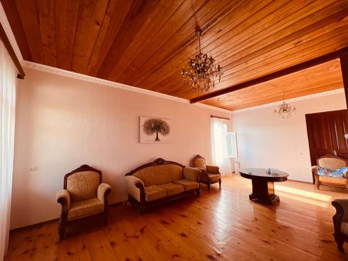 a living room with a couch and chairs and a table at Home Inn Samegrelo in Kheta