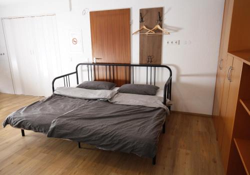a bed with two pillows on it in a room at Appartment mit Parkplatz in Würzburg