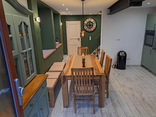 a dining room with a wooden table and chairs at Gästehaus Merlin in Bad Bergzabern