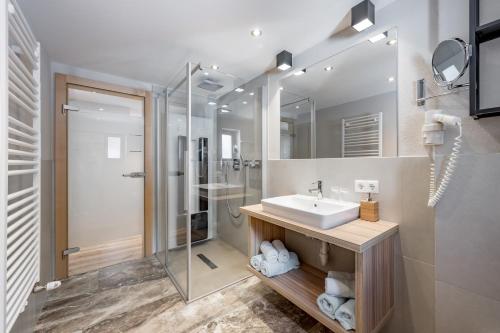a bathroom with a sink and a shower at Aliona Apart in Sölden
