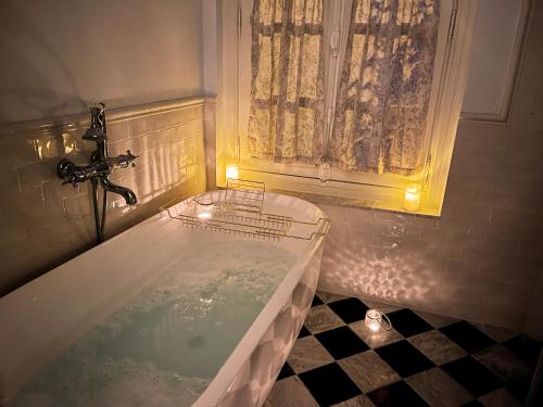 a bath tub in a bathroom with a window at Royal Rose Etretat in Étretat