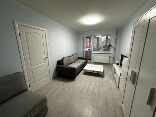 a living room with a couch and a table at Tallinn's Prime Spot: Pae 49 - Near Airport, Concerts & Shops in Tallinn