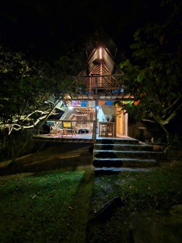 a house at night with stairs leading up to it at Glamping El Árbol en la Casa in San Antonio del Tequendama