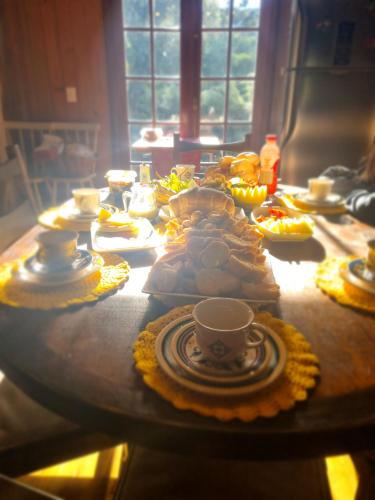 a table with a bunch of food on it at Pousada nevadas da Serra in Urupema