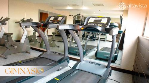 a gym with several tread machines in a room at Altavista Hotel in Reynosa