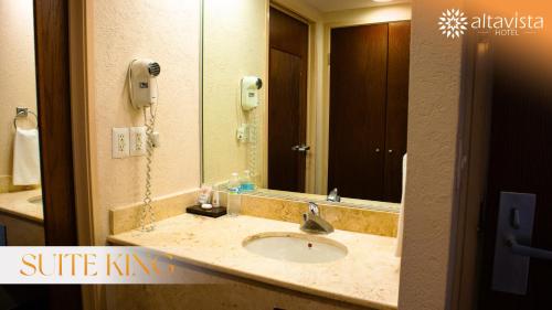 a bathroom with a sink and a mirror at Altavista Hotel in Reynosa