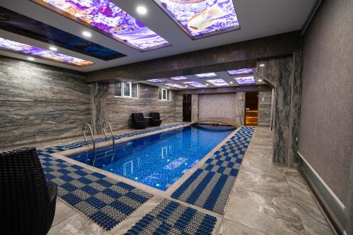 a pool in a building with a ceiling with lights at ART RESIDENCE Hotel in Tashkent