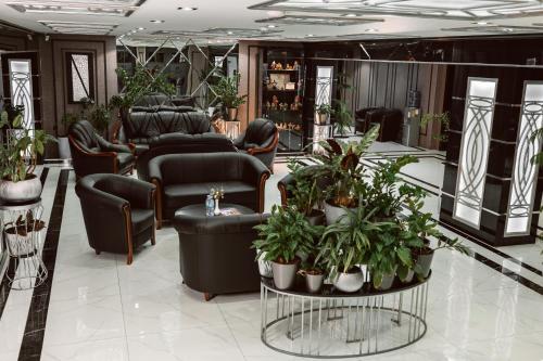 a waiting room with chairs and plants at ART RESIDENCE Hotel in Tashkent