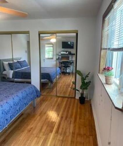 a bedroom with a bed and a desk in it at Nolibs Green Haven Sleeps 12 in Philadelphia