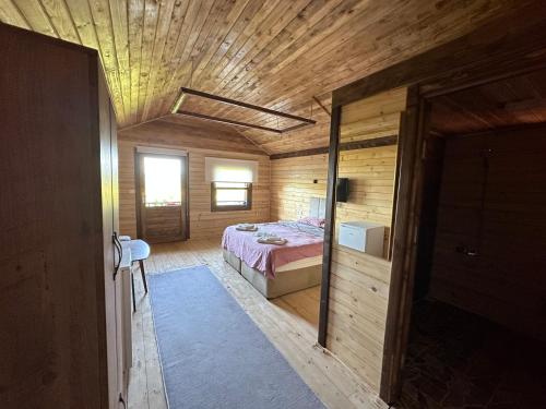 a bedroom with a bed and a wooden ceiling at Ağva Bungalov Adult Only in Sile