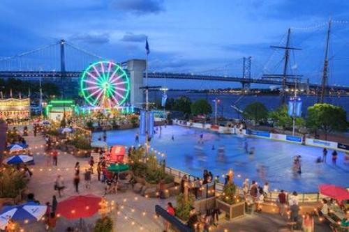 a carnival with a ferris wheel and a crowd of people at Northern Liberties Fishtown Central Cozy Quaint in Philadelphia