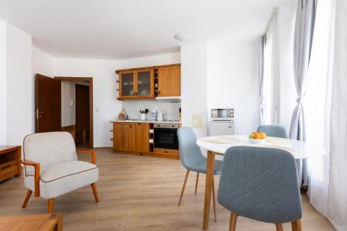 a kitchen and dining room with a table and chairs at Light One Bed Flat next to the Ski Lift in Bansko