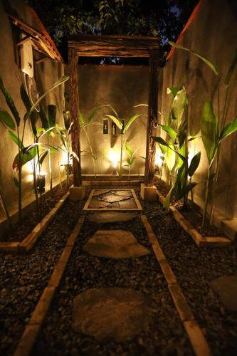 an entrance to a room with plants and lights at Cinnamon Paradise Cinnamon Room in Ahangama