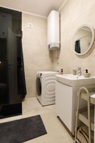 a bathroom with a washing machine and a sink at GO Jahorina by Olympic Gardens in Jahorina