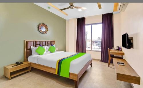 a bedroom with a large bed and a window at Elite Boutique Hotel in Satara
