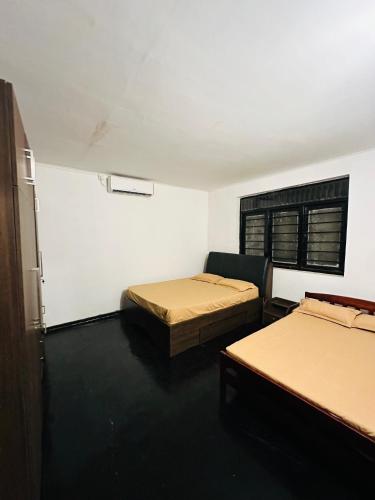 a room with two beds and a window at Leisure Villa in Anuradhapura