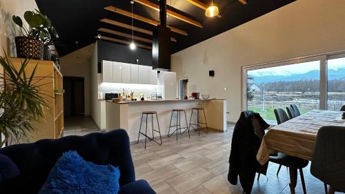 a kitchen and living room with a table and chairs at Stodoła in Ściegny