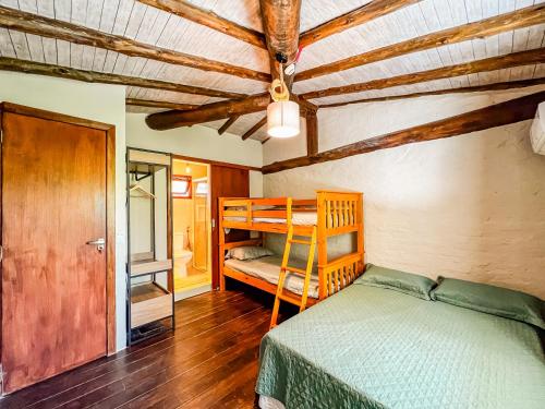 a bedroom with a bed and a bunk bed at Patio Camburi - Flat com Piscina à 60m da Praia de Camburi in São Sebastião