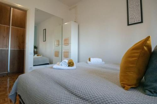 a bedroom with a bed with two pillows on it at Yellow Sky Apartment * Spacious with free parking in Novi Sad