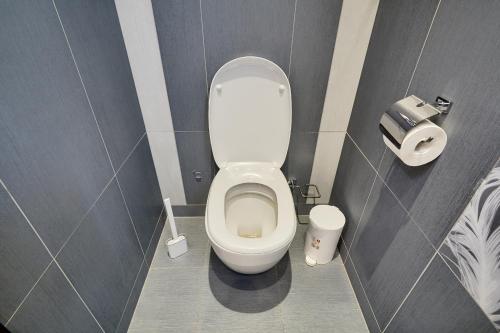 a bathroom with a white toilet in a stall at Botanic Towers the house has a shelter in Kyiv