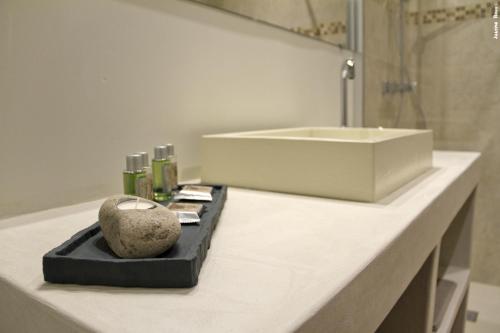 a bathroom counter with a sink and a rock on it at La Rivayne in Lourmarin