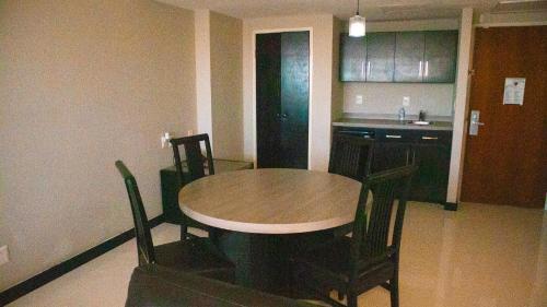 a kitchen with a table and chairs in a room at Altavista Hotel in Reynosa