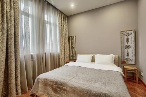 a bedroom with a bed and a large window at Botanic Towers the house has a shelter in Kyiv