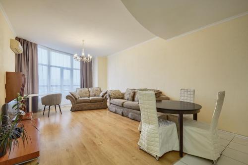 a living room with a couch and a table at Botanic Towers the house has a shelter in Kyiv