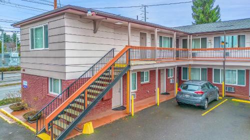 a staircase on the side of a building with a car at Viking Motel in Portland
